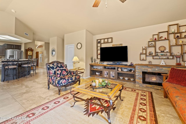 5278 N Saddleback Dr, Prescott Valley, AZ 86314 - living room with light tile patterned flooring, ceiling fan, visible vents, and a fireplace