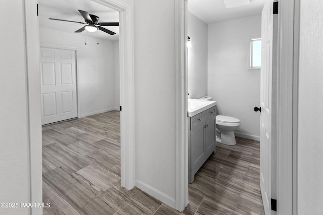 bathroom featuring ceiling fan, vanity, and toilet