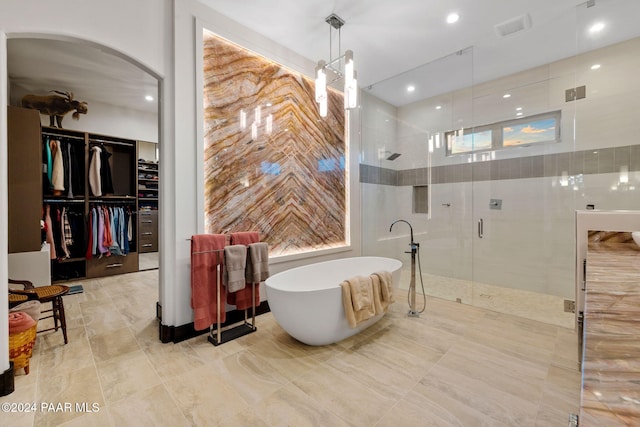 bathroom with separate shower and tub and a healthy amount of sunlight