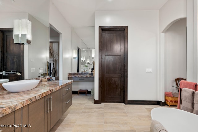 bathroom with tile patterned flooring and vanity