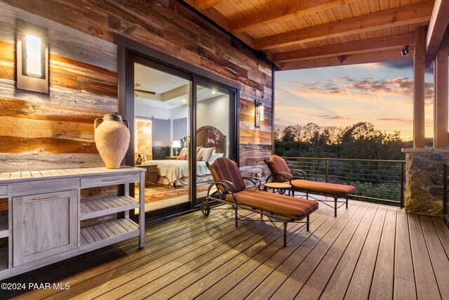 balcony at dusk featuring a mountain view