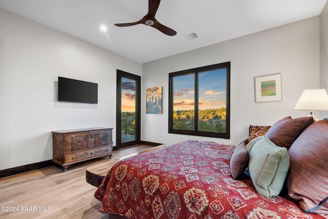 bedroom featuring access to outside, light hardwood / wood-style flooring, and ceiling fan