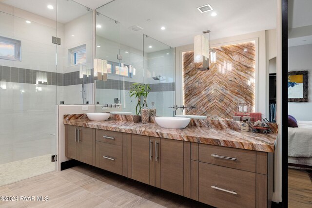 bathroom with tile patterned floors, vanity, and a shower with shower door