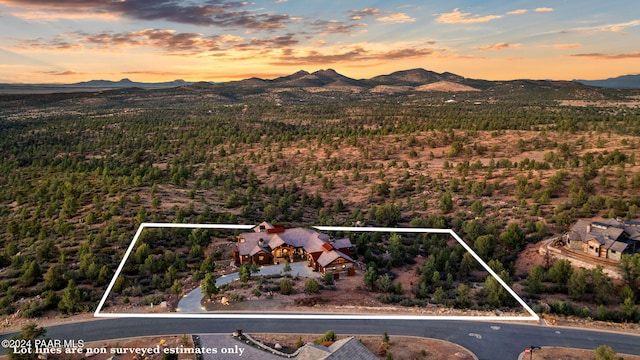 aerial view at dusk featuring a mountain view