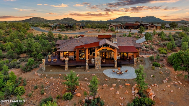 back house at dusk with a mountain view