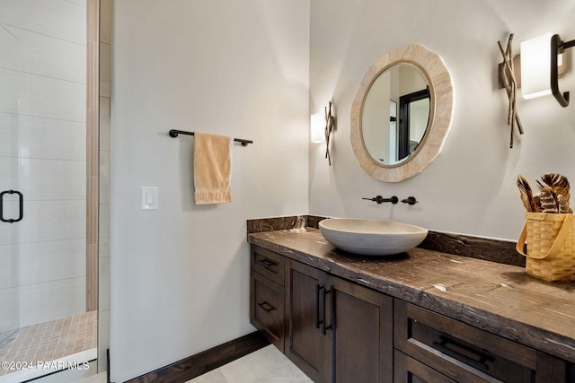 bathroom with tile patterned flooring, vanity, and a shower with shower door