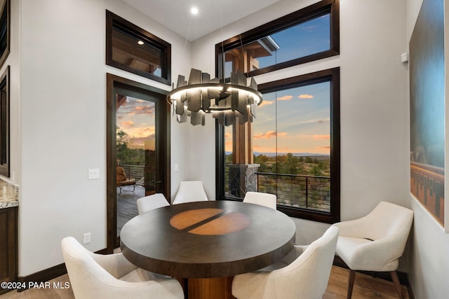 dining room with wood-type flooring and a chandelier