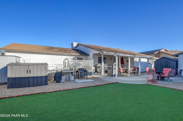 rear view of house with a patio area and a lawn