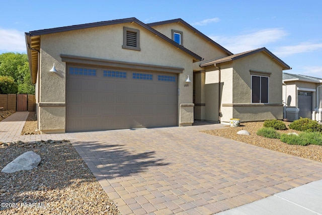 12691 E De La Cruz St, Dewey-Humboldt, AZ 86327 - view of front facade with a garage, stucco siding, and decorative driveway