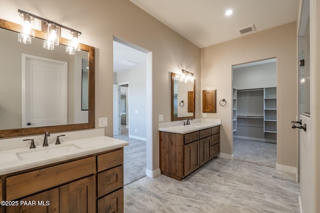 bathroom with two vanities and baseboards