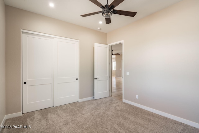 unfurnished bedroom featuring carpet flooring, baseboards, a closet, and recessed lighting