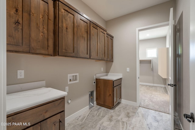 laundry area with cabinet space, hookup for a washing machine, hookup for a gas dryer, and baseboards