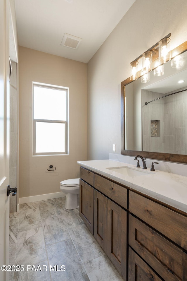 full bathroom with vanity, toilet, and marble look tiles
