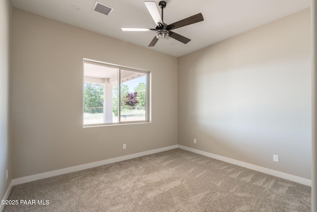 unfurnished room featuring light colored carpet, baseboards, and ceiling fan