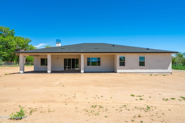 rear view of house featuring stucco siding and a patio