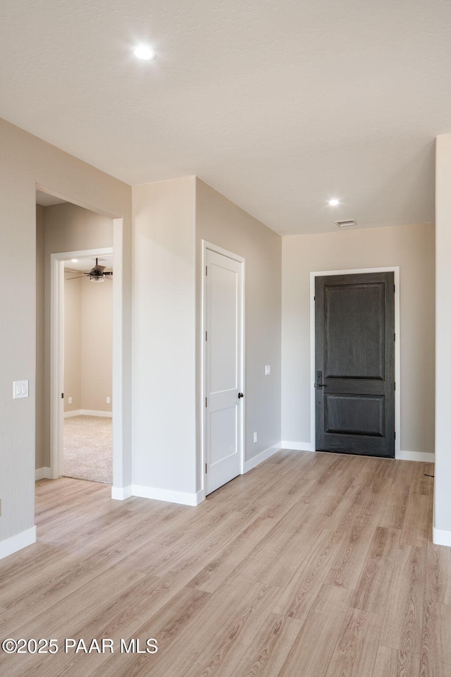 unfurnished room featuring light wood finished floors, baseboards, a ceiling fan, and recessed lighting