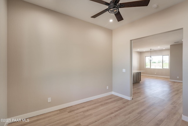 unfurnished room with a ceiling fan, light wood finished floors, recessed lighting, baseboards, and a smoke detector