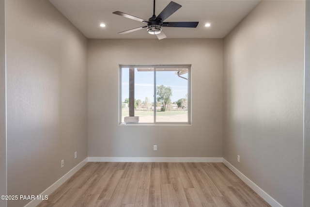 spare room featuring light wood finished floors, a ceiling fan, recessed lighting, and baseboards