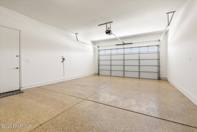 garage with baseboards and a garage door opener