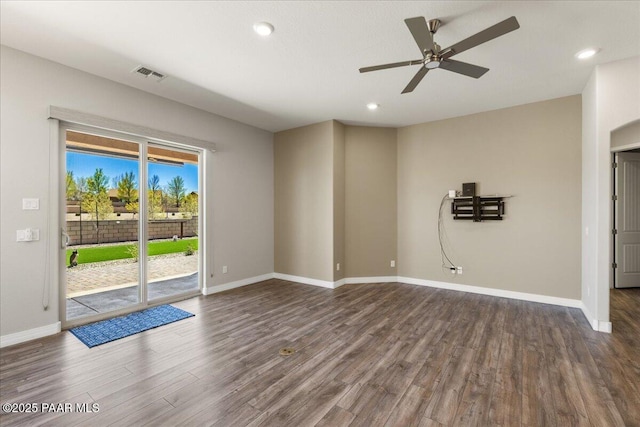 empty room featuring baseboards, visible vents, recessed lighting, a ceiling fan, and dark wood-type flooring