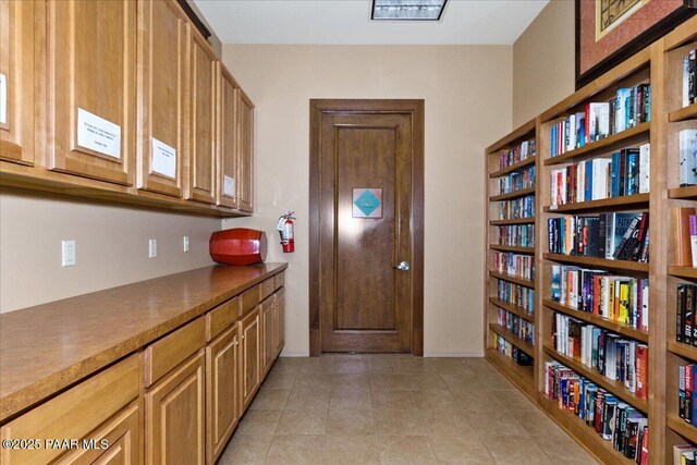 interior space featuring baseboards and light tile patterned floors