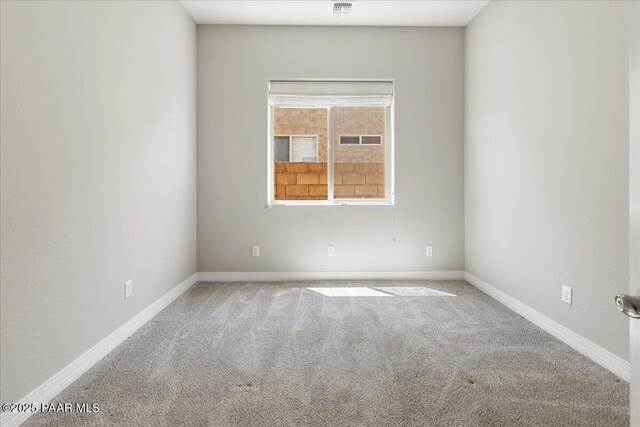 empty room featuring baseboards, carpet flooring, and visible vents
