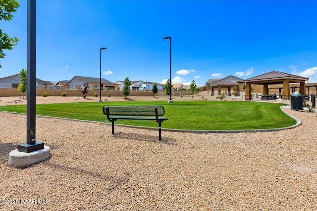 surrounding community with a yard, a gazebo, fence, and a residential view