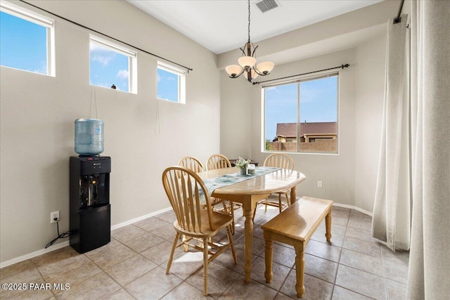 dining room featuring baseboards, an inviting chandelier, visible vents, and light tile patterned floors
