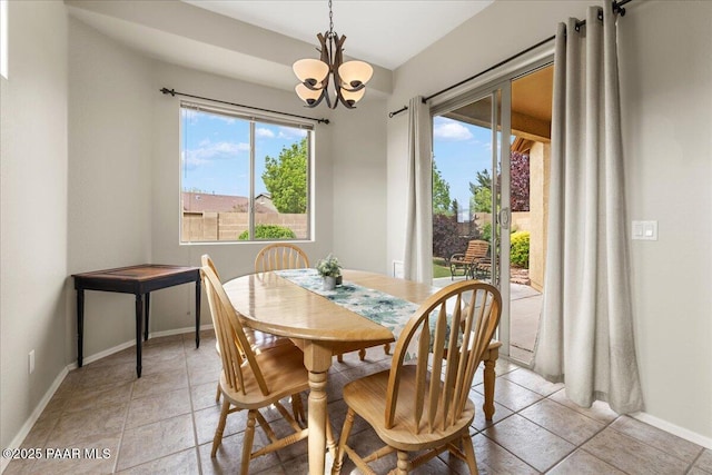 dining room featuring an inviting chandelier, baseboards, and light tile patterned floors