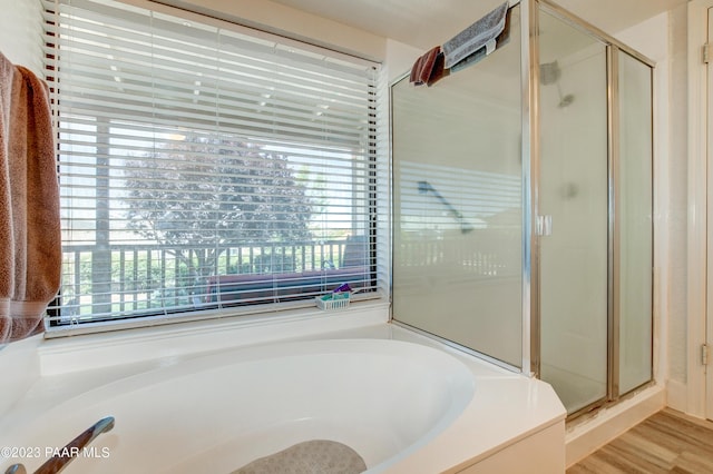 3096 Montana Dr, Prescott, AZ 86301 - bathroom with a healthy amount of sunlight, a stall shower, a garden tub, and wood finished floors