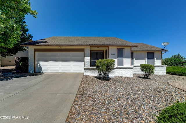 3096 Montana Dr, Prescott, AZ 86301 - ranch-style house featuring brick siding, a garage, roof with shingles, and concrete driveway