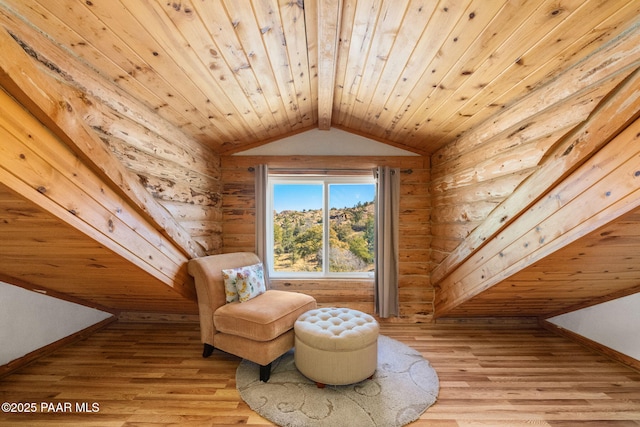 sitting room featuring lofted ceiling with beams, rustic walls, light hardwood / wood-style floors, and wood ceiling