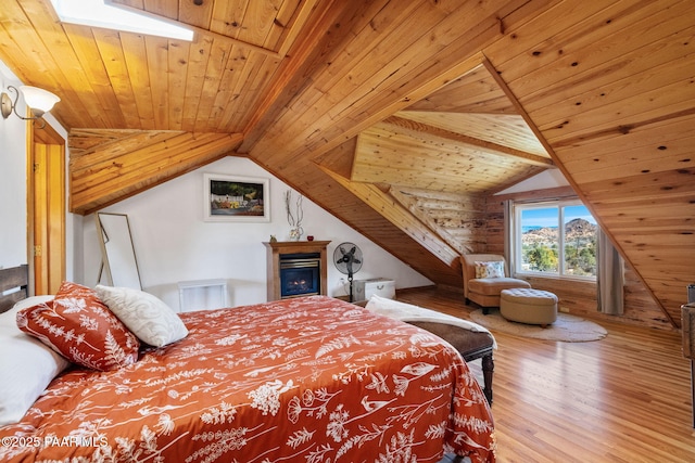 bedroom featuring hardwood / wood-style floors, vaulted ceiling, and wooden ceiling