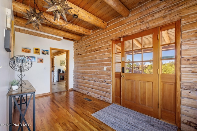 foyer featuring beam ceiling, wood-type flooring, and wood ceiling