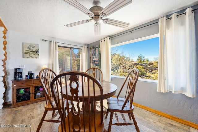 dining space featuring hardwood / wood-style flooring, ceiling fan, and plenty of natural light