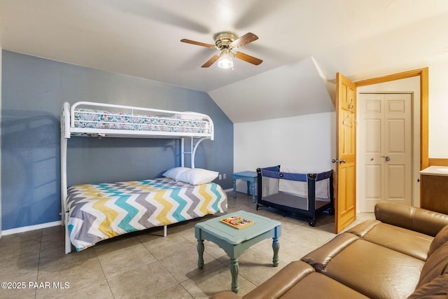 bedroom with ceiling fan, lofted ceiling, and tile patterned floors