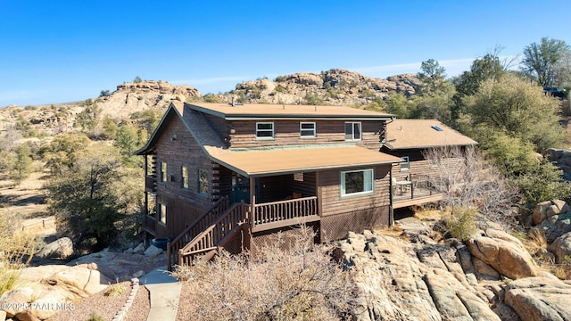 cabin featuring a deck with mountain view