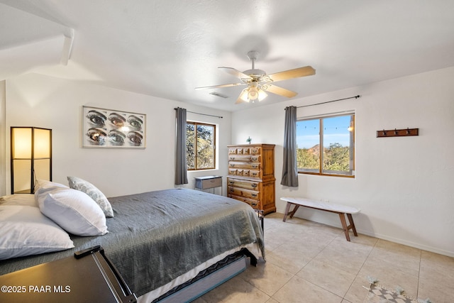 tiled bedroom featuring ceiling fan