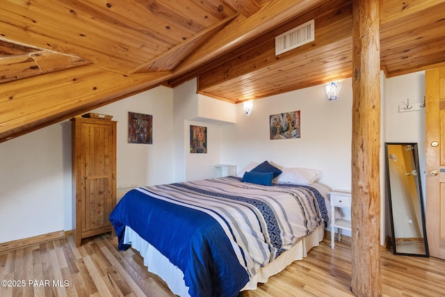 bedroom with vaulted ceiling, wood ceiling, and light hardwood / wood-style floors