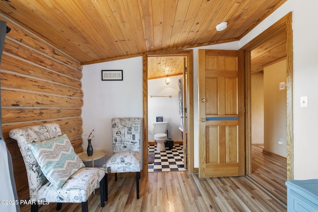 living area featuring lofted ceiling, wooden ceiling, and light hardwood / wood-style flooring