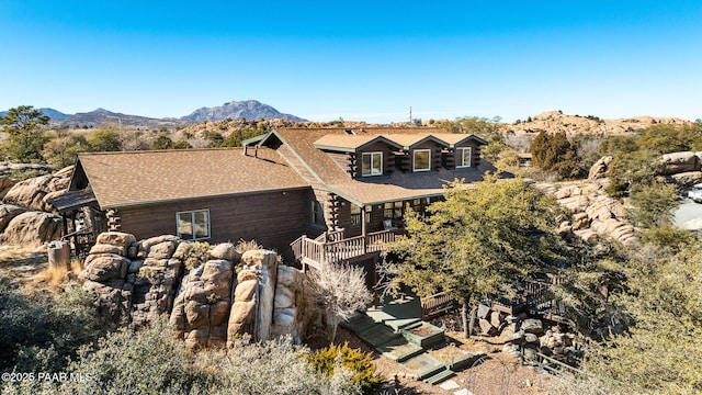 exterior space with a deck with mountain view