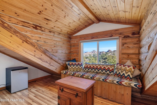 unfurnished living room with wooden ceiling, log walls, light hardwood / wood-style floors, and vaulted ceiling with beams