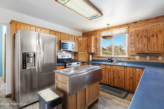 kitchen featuring sink, a center island, hanging light fixtures, hardwood / wood-style flooring, and stainless steel appliances