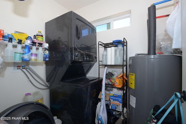 laundry area featuring water heater and stacked washer and clothes dryer