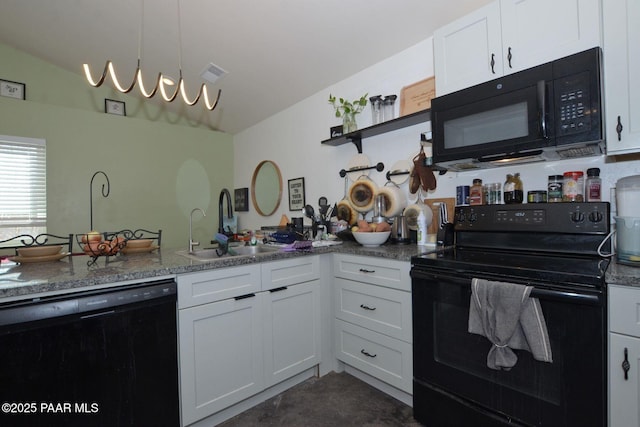 kitchen with sink, black appliances, white cabinetry, and dark stone counters