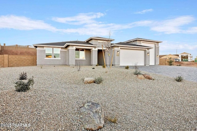 8595 N Isabella Ct, Prescott Valley, AZ 86315 - view of front facade featuring fence, an attached garage, driveway, and stucco siding