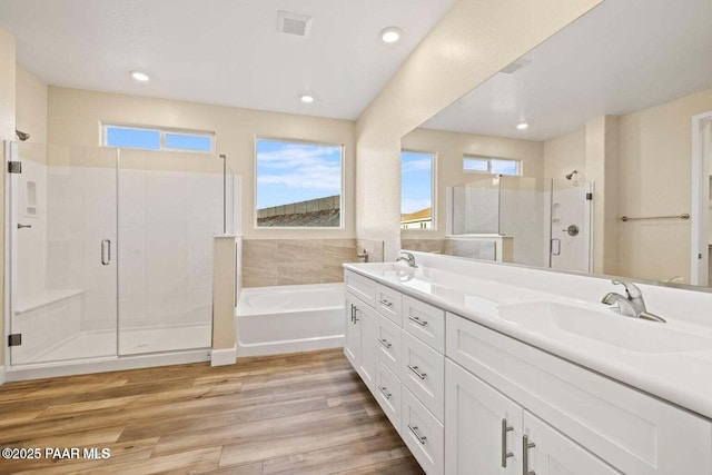 8595 N Isabella Ct, Prescott Valley, AZ 86315 - full bathroom with a bath, a sink, double vanity, a stall shower, and wood finished floors