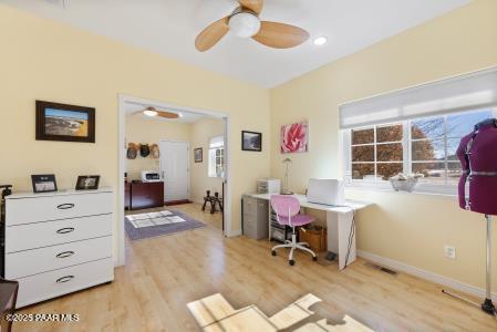 office space featuring light hardwood / wood-style floors and ceiling fan