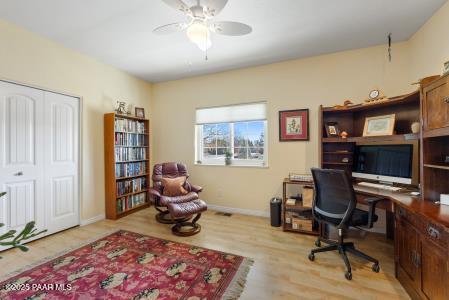 home office with ceiling fan and light wood-type flooring