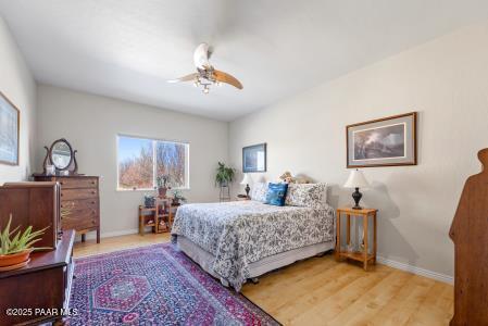 bedroom with hardwood / wood-style flooring and ceiling fan